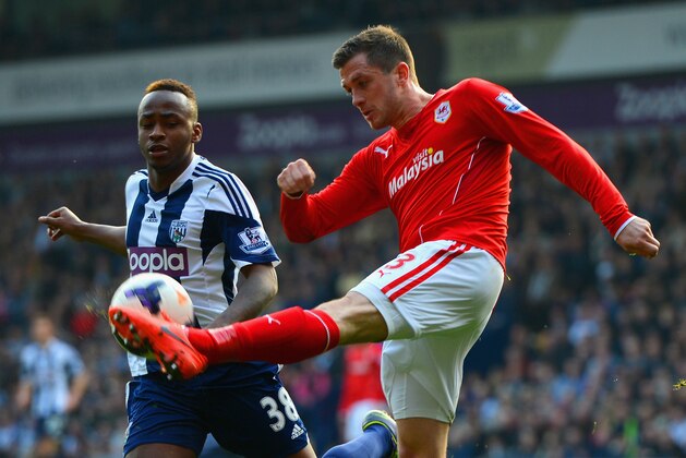 WEST BROMWICH, ENGLAND - MARCH 29: Andrew Taylor of Cardiff City and Saido Berahino of West Brom compete for the ball during the Barclays Premier League match between West Bromwich Albion and Cardiff City at The Hawthorns on March 29, 2014 in West Bromwich, England.  (Photo by Michael Regan/Getty Images)