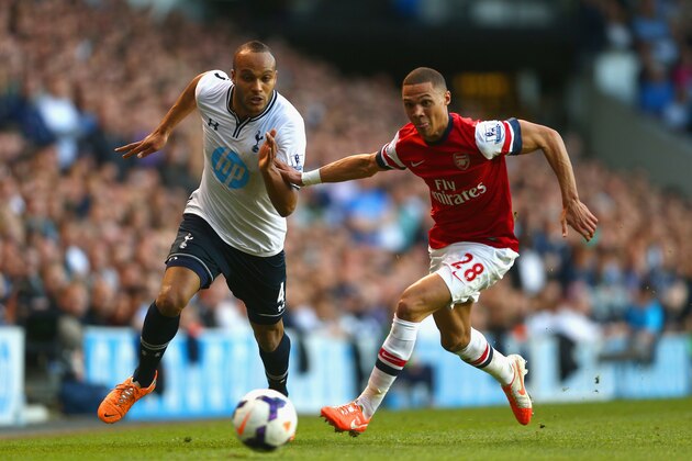 LONDON, ENGLAND - MARCH 16:  Kieran Gibbs of Arsenal and Younes Kaboul of Tottenham Hotspur battle for the ball during the Barclays Premier League match between Tottenham Hotspur and Arsenal at White Hart Lane on March 16, 2014 in London, England.  (Photo by Paul Gilham/Getty Images)