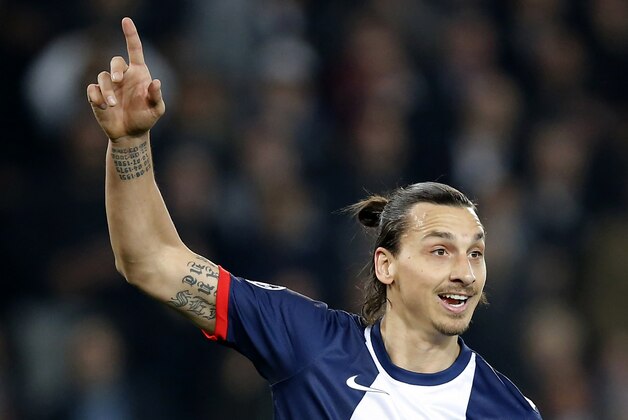 Paris Saint Germain's Swedish Zlatan Ibrahimovic, shows one to his teammate where to play the ball during a Champions League last 16 second leg soccer match between Paris Saint Germain against Bayer Leverkusen at Parc des Princes stadium in Paris, Wednesday, March 12, 2014. (AP Photo/Michel Euler)