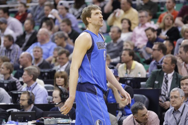 Dallas Mavericks' Dirk Nowitzki looks at the score board as he walks to the bench in the first quarter during an NBA basketball game against the Utah Jazz Wednesday, March 12, 2014, in Salt Lake City. (AP Photo/Rick Bowmer)