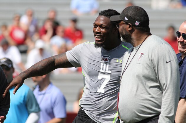 South Carolina defensive end Jadeveon Clowney competes in a drill for NFL representatives at South Carolina football pro day in Columbia, S.C., Wednesday, April 2, 2014. Laughing at far right is Houston Texans coach Bill O'Brien.  (AP Photo/Mary Ann Chastain)