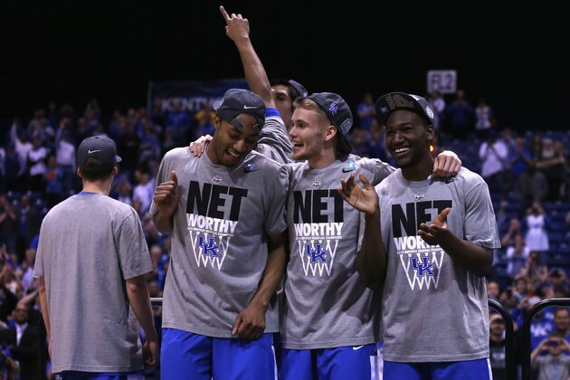 INDIANAPOLIS, IN - MARCH 30:  Dominique Hawkins #25 and Jarrod Polson #3 of the Kentucky Wildcats pose with teammates after defeating the Michigan Wolverines 75 to 72 in the midwest regional final of the 2014 NCAA Men's Basketball Tournament at Lucas Oil Stadium on March 30, 2014 in Indianapolis, Indiana.  (Photo by Jonathan Daniel/Getty Images)