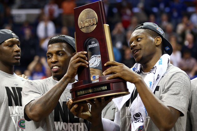 MEMPHIS, TN - MARCH 29: Casey Prather #24 and Will Yeguete #15 of the Florida Gators celebrate with the trophy after defeating the Dayton Flyers 62-52 in the south regional final of the 2014 NCAA Men's Basketball Tournament at the FedExForum on March 29, 2014 in Memphis, Tennessee.  (Photo by Streeter Lecka/Getty Images)