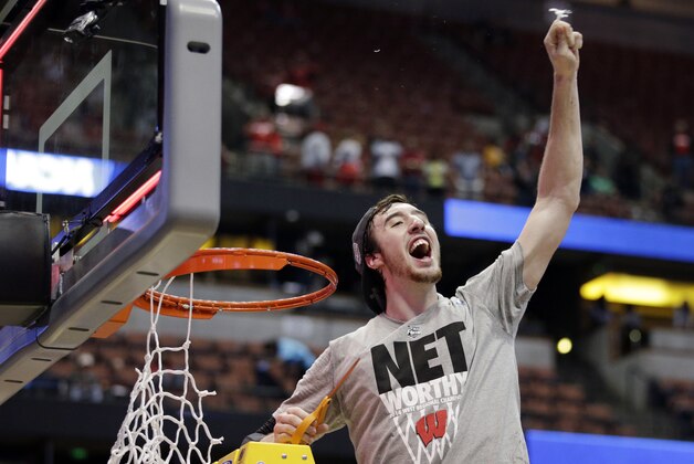 Wisconsin 's Frank Kaminsky cuts down the net after a regional final NCAA college basketball tournament game against Arizona, Saturday, March 29, 2014, in Anaheim, Calif. Wisconsin won 64-63 in overtime. (AP Photo/Jae C. Hong)