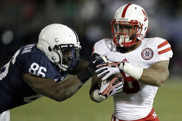 Nebraska running back Ameer Abdullah (8) gets past Penn State defensive end C.J. Olaniyan (86) during the fourth quarter of an NCAA college football game against Penn State in State College, Pa., Saturday, Nov. 23, 2013. Nebraska  won 23-20. (AP Photo/Gene J. Puskar)