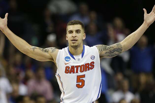 Florida guard Scottie Wilbekin (5) celebrates his basket against Dayton's Vee Sanford during the first half in a regional final game at the NCAA college basketball tournament, Saturday, March 29, 2014, in Memphis, Tenn. (AP Photo/John Bazemore)