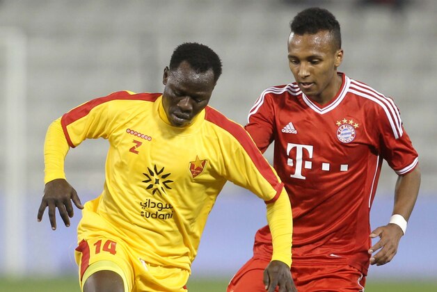 FILE - In this Jan. 9, 2014, file photo, Bayern Munich's Julian Green, right, of Munich, and Balla Jabir, of Al-Merrikh, challenge for the ball, during their friendly soccer match, at Al-Saad stadium in Doha. Green has joined the U.S. soccer team, a glistening talent still developing, a youngster who grew up in Germany with regular trips to see his father in Florida. He will make his debut for the United States against Mexico on Wednesday, April 2. (AP Photo/Osama Faisal, File)