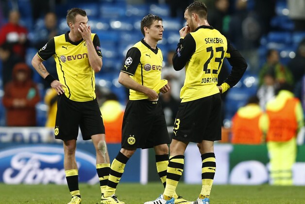 Dortmund's Kevin Grosskreutz, Jonas Hofmann and Julian Schieber, from left, ponder after the Champions League quarterfinal first leg soccer match between Real Madrid and Borussia Dortmund at the Santiago Bernabeu   stadium in Madrid, Spain, Wednesday, April 2, 2014. (AP Photo/Andres Kudacki)