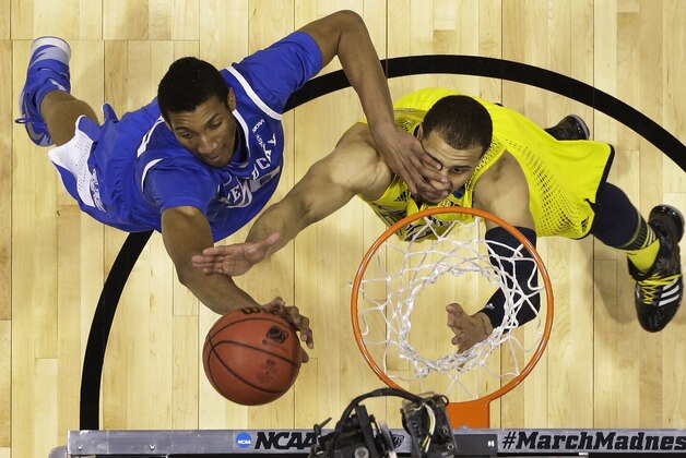Kentucky's Marcus Lee, left, and Michigan's Jordan Morgan go after a rebound during the first half of an NCAA Midwest Regional final college basketball tournament game Sunday, March 30, 2014, in Indianapolis.  (AP Photo/Michael Conroy)