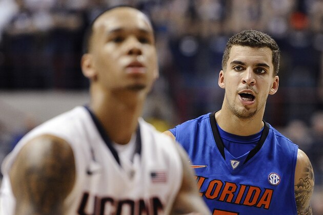 Florida's Scottie Wilbekin, right, watches Connecticut's Shabazz Napier shoot a free throw during the first half of an NCAA college basketball game, Monday, Dec. 2, 2013, in Storrs, Conn. (AP Photo/Jessica Hill)