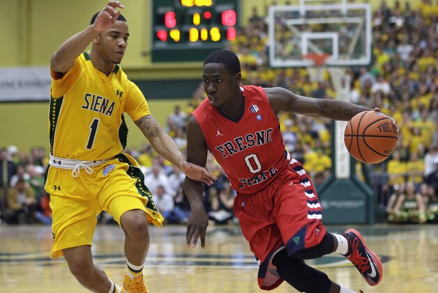 Fresno State's Emmanuel Owootoah drives against Siena's Marquis Wright (1) during the first half of a College Basketball Invitational championship series game Wednesday, April 2, 2014, in Loudonville, N.Y. (AP Photo/Mike Groll)