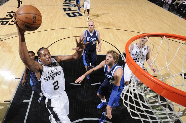 San Antonio Spurs guard Danny Green (4) follows through with a shot over Dallas Mavericks guard Monta Ellis (11) in the second half of an NBA basketball game, Thursday, Dec. 26, 2013, in Dallas. The San Antonio Spurs won 116-107. (AP Photo/Matt Strasen)
