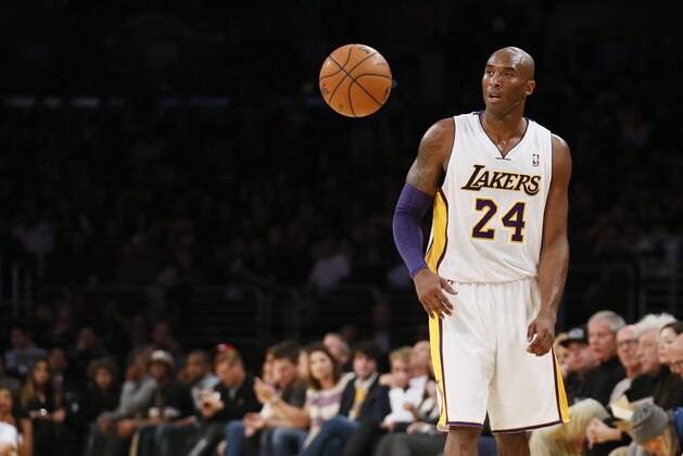 Los Angeles Lakers' Kobe Bryant allows the ball to bounce freely in front of him as he controls the ball against the Toronto Raptors during the first half of an NBA basketball game in Los Angeles, Sunday, Dec. 8, 2013. It was Bryant's first game back after a torn left Achilles tendon injury on April 12th and the Raptors won 106-94. (AP Photo/Danny Moloshok)
