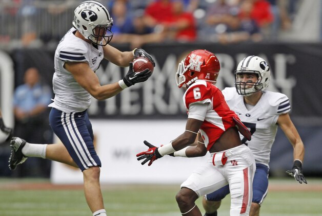 BYU's Daniel Sorensen, left, intercepts a pass intended for Houston's Larry McDuffey (6) during the first half of an NCAA college football game, Saturday, Oct. 19, 2013 in Houston. (AP Photo/Eric Christian Smith)