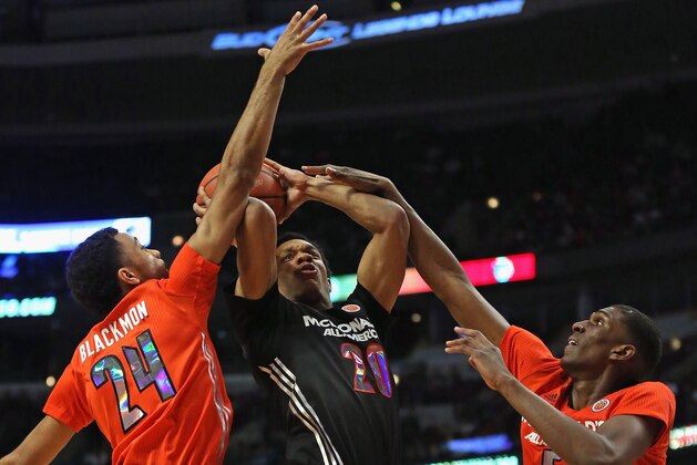 CHICAGO, IL - APRIL 2: Rashad Vaughn #20 of the west team tries to get off a shot under pressure from James Blackmon Jr. #24 and Kevon Looney #5 of the east team during the 2014 McDonald's All American Game at United Center on April 2, 2014 in Chicago, Illinois. (Photo by Jonathan Daniel/Getty Images)