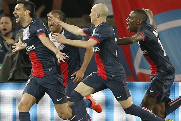 PSG's Javier Pastore, left, celebrates after scoring his sides 3rd goal during the Champions League quarterfinal first leg soccer match between PSG and Chelsea, at the Parc des Princes stadium, in Paris, Wednesday, April 2, 2014. (AP Photo/Christophe Ena)