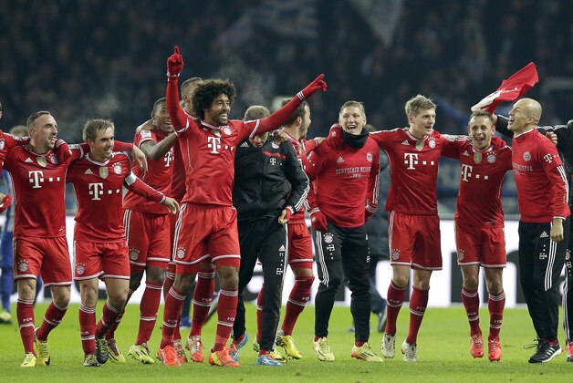 Bayern's Arjen Robben of the Netherlands, right, Bayern's Franck Ribery of France, left, and their teammates celebrate winning the German soccer championship after the German Bundesliga soccer match between Hertha BSC Berlin and Bayern Munich in Berlin, Germany, Tuesday, March 25, 2014. (AP Photo/Michael Sohn)