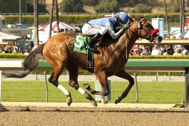 FILE - In this April 6, 2013 image provided by Benoit Photo, Goldencents, Kevin Krigger up, race to win the Grade I  $750,000 Santa Anita Derby horse race  at Santa Anita Park in Arcadia, Calif. Doug Krigger will be aboard Goldencents in the Kentucky Derby and could become the first black jockey since 1902 to win America's premier horse race.  (AP Photo/Benoit Photo, File)