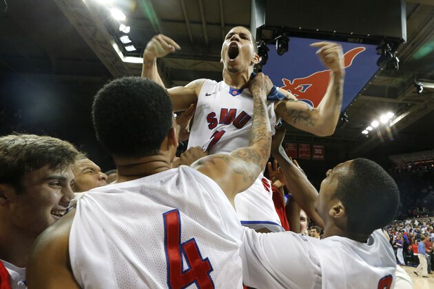 SMU guard Nic Moore (11) is lifted in the air and celebrates with fans after an NCAA college basketball game against California in the quarterfinals of the NIT Wednesday, March 26, 2014, in Dallas. SMU won 67-65. (AP Photo/Sharon Ellman)