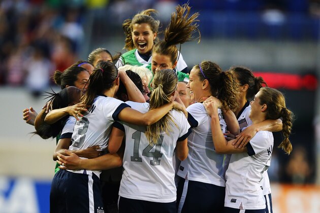 HARRISON, NJ - JUNE 20:  Abby Wambach #20 of the USA celebrates with her teamates after passing Mia Hamm in alltime International total goals scored with her159th International goal against  Korea Republic during the first half of their game at Red Bull Arena on June 20, 2013 in Harrison, New Jersey.  (Photo by Al Bello/Getty Images)
