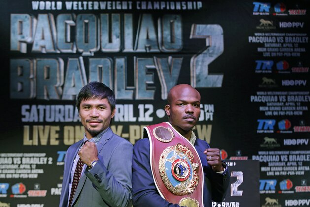 Boxer Manny Pacquiao, of the Phillipines, left, poses for a photo with Timothy Bradley of Indio, Ca., the current WBO World Welterweight champion, during a press conference,Thursday, Feb. 6, 2014, in New York.  The pair will face off in a rematch April 12, 2014, in Las Vegas. Bradley won their first encounter. (AP Photo/Kathy Willens)