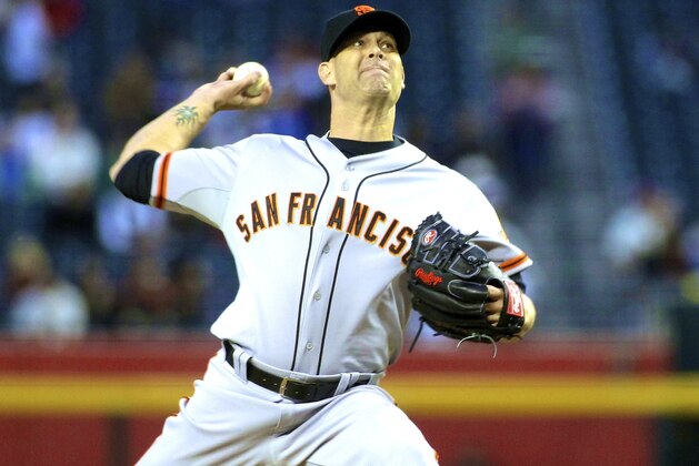 San Francisco Giants' Tim Hudson throws a pitch against the Arizona Diamondbacks during the first inning of a baseball game, Wednesday, April 2, 2014, in Phoenix. (AP Photo/Ross D. Franklin)