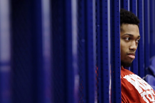 Louisville center Zach Price relaxes in the locker room, Saturday, March 30, 2013, in Indianapolis. Louisville is scheduled to play Duke in the Midwest Regional final in the NCAA college basketball tournament on Sunday. (AP Photo/Darron Cummings)