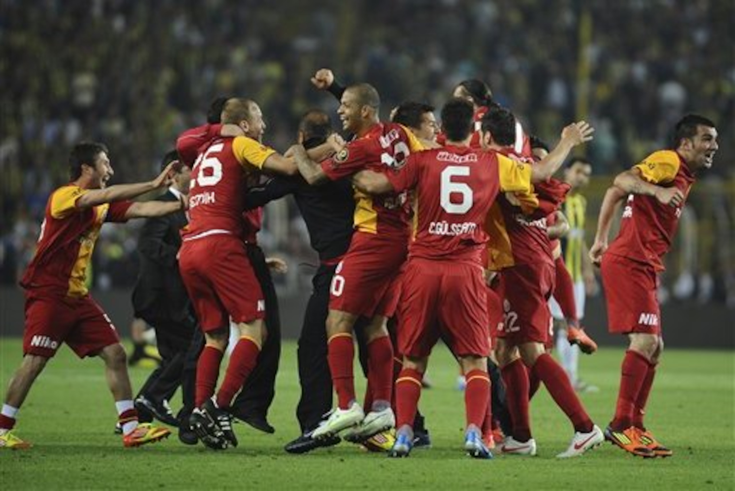 Galatasaray players celebrate after their soccer derby match against Fenerbahce in Istanbul, Turkey, Saturday, May 12, 2012.  One fan was reportedly stabbed after Galatasaray's Turkish league championship triggered violence at the goalless derby match with Fenerbahce and across the country on Saturday. (AP Photo)
