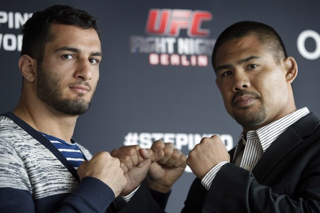 Dutch middleweight fighter Gegard Mousasi, left, and Mark Munoz from the US, right, pose for the photographers prior to a joint press conference in Berlin, Germany, Thursday, April 3, 2014. Munoz and Mousasi will fight during a UFC (Ultimate Fighting Championship) fight night in Berlin on Saturday, May 31, 2014. (AP Photo/Michael Sohn)