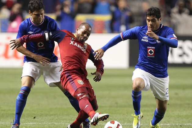 SANDY, UT - SEPTEMBER 19: Andy Williams #77 of Real Salt Lake is pulled down by Julio Cesar Dominguez #4 and Javier Orozco #27 of Cruz Azul during the second half of an CONCACAF soccer game October 19, 2010 at Rio Tinto Stadium in Sandy, Utah. Real Salt Lake beat Cruz Azul 3-1. (Photo by George Frey/Getty Images)