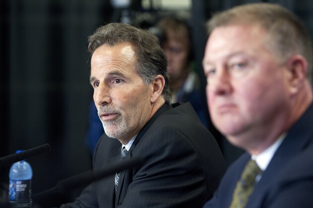 VANCOUVER, CANADA - JUNE 25: Vancouver Canucks head coach John Tortorella (L) speaks while General Manager Mike Gillis looks on during a press conference announcing him as the new head coach of the team, June 25, 2013 at Rogers Arena in Vancouver, British Columbia, Canada.  (Photo by Rich Lam/Getty Images)