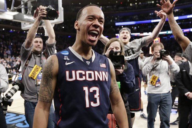Connecticut's Shabazz Napier (13) celebrates after his team defeated Michigan State 60-54 in a regional final at the NCAA college basketball tournament, Sunday, March 30, 2014, in New York. Napier scored 17 points of his 25 points in the second half. (AP Photo/Frank Franklin II)