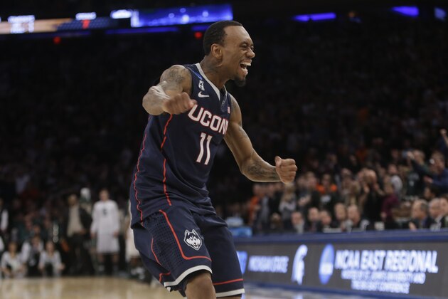 Connecticut's Ryan Boatright (11) celebrates during the second half of a regional final against Michigan State in the NCAA college basketball tournament  Sunday, March 30, 2014, in New York. Connecticut won the game 60-54. (AP Photo/Frank Franklin II)