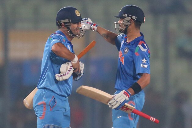 DHAKA, BANGLADESH - MARCH 28:  Virat Kohli and MS Dhoni of India embrace after winning the ICC World Twenty20 Bangladesh 2014 match between Bangladesh and India at Sher-e-Bangla Mirpur Stadium on March 28, 2014 in Dhaka, Bangladesh.  (Photo by Scott Barbour/Getty Images)