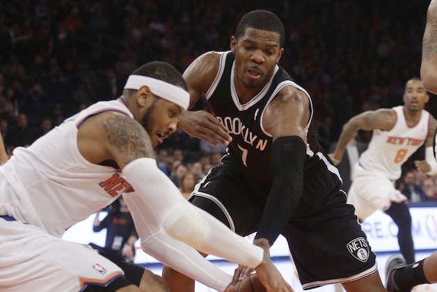 Brooklyn Nets' Joe Johnson (7) and New York Knicks' Carmelo Anthony (7) fight for control of the ball during the first half of an NBA basketball game Wednesday, April 2, 2014, in New York.  (AP Photo/Frank Franklin II)