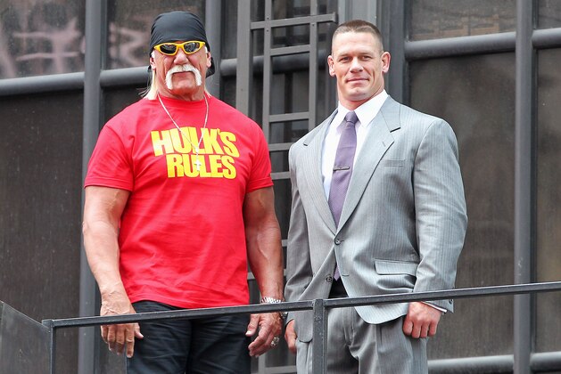 This image released by Starpix shows professional wresting personalities Hulk Hogan, left, and John Cena on top of the The Hard Rock Cafe during a news conference for Wrestlemania 30 on Tuesday, April 1, 2014 in New York. Wrestlemania 30 will be held on Sunday, April 6 in New Orleans .  (AP Photo/Starpix, Dave Allocca)