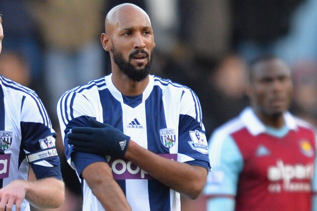 LONDON, ENGLAND - DECEMBER 28:  Nicolas Anelka of West Brom touches his sleeve as he celebrates scoring their first goal during the Barclays Premier League match between West Ham United and West Bromwich Albion at Boleyn Ground on December 28, 2013 in London, England.  (Photo by Christopher Lee/Getty Images)