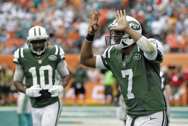 New York Jets quarterback Geno Smith (7) celebrates with teammate Santonio Holmes (10) after his seven-yard touchdown run against the Miami Dolphins during the second quarter of an NFL football game Sunday, Dec. 29, 2013, in Miami Gardens, Fla. (AP Photo/Alan Diaz)