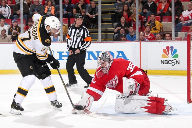 DETROIT, MI - APRIL 2:  Jimmy Howard #35 of the Detroit Red Wings makes a break away save on Patrice Bergeron #37 of the Boston Bruins during an NHL game on April 2, 2014 at Joe Louis Arena in Detroit, Michigan. (Photo by Dave Reginek/NHLI via Getty Images)