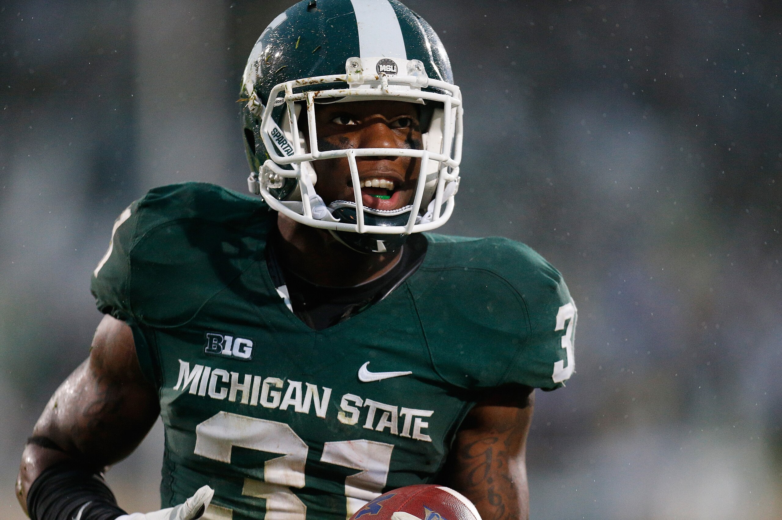 EAST LANSING, MI - NOVEMBER 02:  Darqueze Dennard #31 of the Michigan State Spartans celebrates his fourth-quarter interception against the Michigan Wolverines at Spartan Stadium on November 2, 2013 in East Lansing, Michigan. Michigan State won the game 29-6. (Photo by Gregory Shamus/Getty Images)