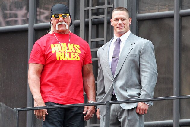 This image released by Starpix shows professional wresting personalities Hulk Hogan, left, and John Cena on top of the The Hard Rock Cafe during a news conference for Wrestlemania 30 on Tuesday, April 1, 2014 in New York. Wrestlemania 30 will be held on Sunday, April 6 in New Orleans .  (AP Photo/Starpix, Dave Allocca)