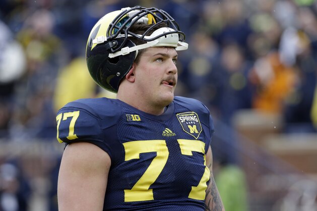 Michigan offensive linesman Taylor Lewan watches during an NCAA college football spring scrimmage in Ann Arbor, Mich., Saturday, April 13, 2013. (AP Photo/Carlos Osorio)