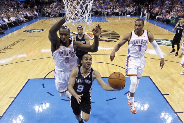 San Antonio Spurs guard Tony Parker (9) goes up for a shot in front of Oklahoma City Thunder forward Serge Ibaka (9) and guard Russell Westbrook (0) during the second quarter of an NBA basketball game in Oklahoma City, Thursday, April 3, 2014. Oklahoma City won 106-94. (AP Photo/Sue Ogrocki)