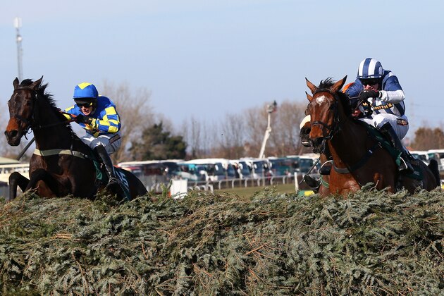 LIVERPOOL, ENGLAND - APRIL 06:  Ryan Mania riding Auroras Encore clears the last fence ahead of Teaforthree ridden by Nick Schofield on their way to victory in the John Smiths Grand National at Aintree Racecourse on April 6, 2013 in Liverpool, England.  (Photo by Alex Livesey/Getty Images)