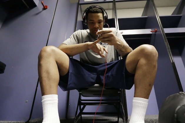 Syracuse's DaJuan Coleman clips his fingernails  in the locker room before practice for their NCAA Final Four tournament college basketball semifinal game against Michigan, Friday, April 5, 2013, in Atlanta. Louisville plays Wichita State in a semifinal game on Saturday. (AP Photo/David J. Phillip)