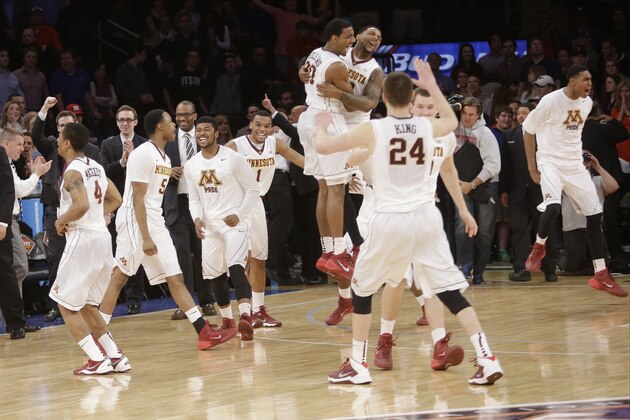 Austin Hollins (20), Deandre Mathieu (4) and Joey King (24) celebrate with teammates after defeating SMU 65-63 in an NCAA college basketball game in the final of the NIT on Thursday, April 3, 2014, in New York. Minnesota won 65-63. (AP Photo/Frank Franklin II)