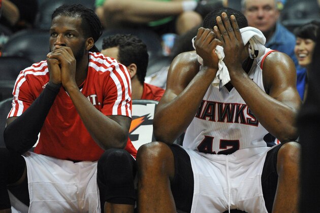 Atlanta Hawks' Elton Brand (42) and DeMarre Carroll sit on the bench as time runs out in the second half of their NBA basketball game against the Portland Trail Blazers Thursday, March 27, 2014, in Atlanta. Portland won 100-85. (AP Photo/David Tulis)