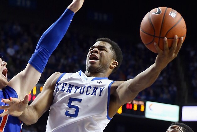 Kentucky guard Andrew Harrison (5) runs on Florida guard Michael Frazier II (20) during the first half of an NCAA college basketball game in the Championship round of the Southeastern Conference men's tournament, Sunday, March 16, 2014, in Atlanta. (AP Photo/Steve Helber)