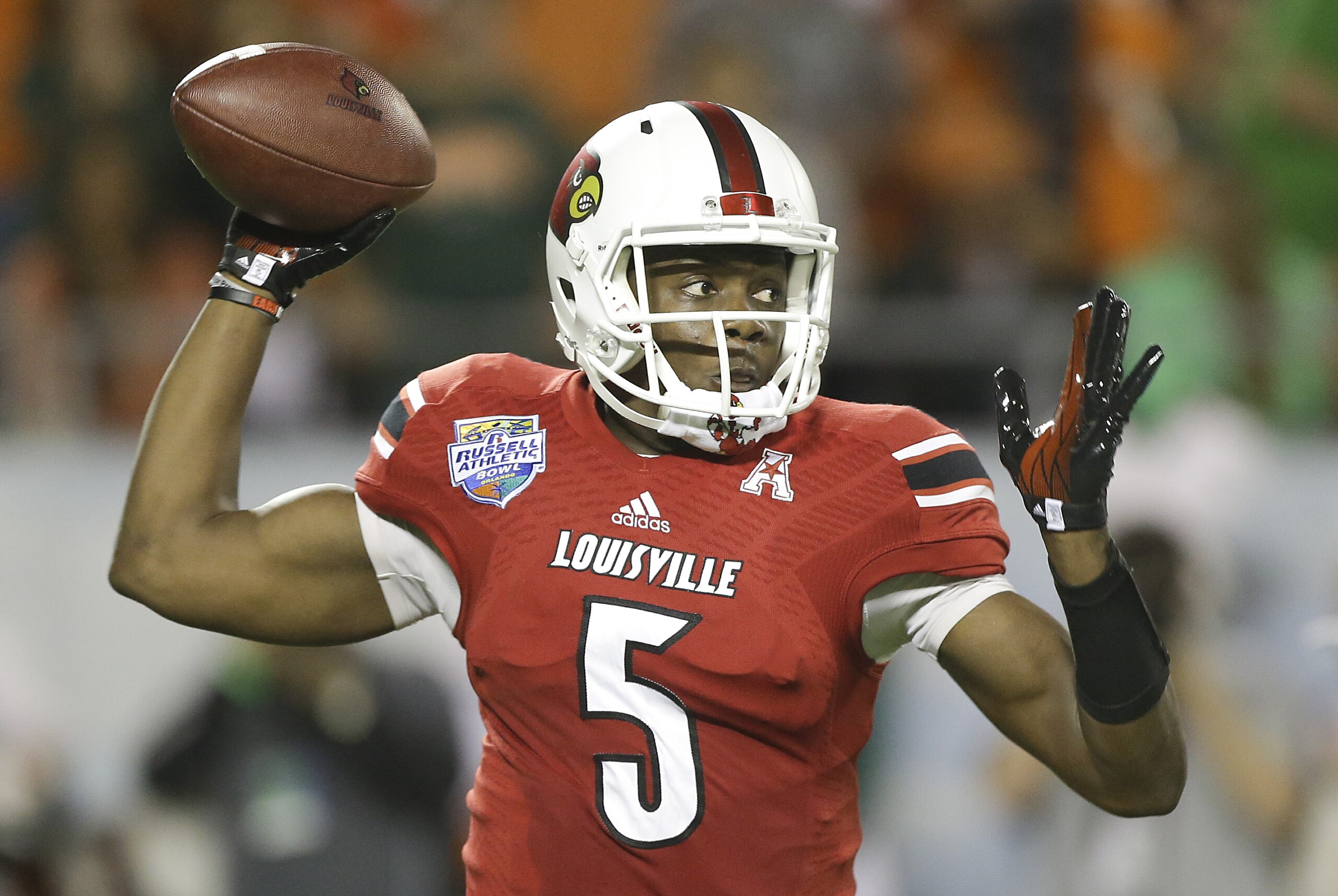 Louisville quarterback Teddy Bridgewater throws a pass during the first half of the Russell Athletic Bowl NCAA college football game against Miami in Orlando, Fla., Saturday, Dec. 28, 2013.(AP Photo/John Raoux)