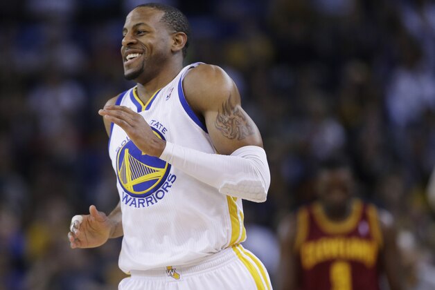 Golden State Warriors' Andre Iguodala smiles after making a three-point basket against the Cleveland Cavaliers during the first half of an NBA basketball game on Friday, March 14, 2014, in Oakland, Calif. (AP Photo/Marcio Jose Sanchez)